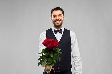 Image showing happy man with bunch of red roses