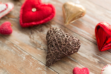 Image showing heart shaped decorations on wooden background