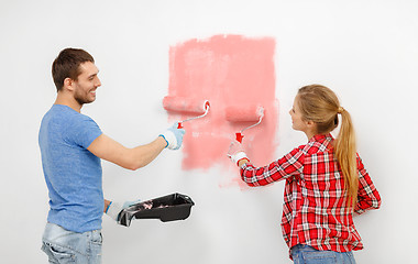 Image showing happy couple painting wall at home