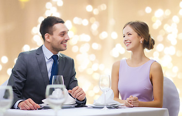 Image showing happy couple at restaurant over festive lights