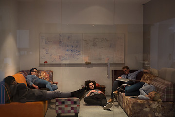 Image showing software developers sleeping on sofa in creative startup office