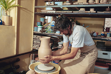 Image showing Creating a jar or vase of white clay close-up. Master crock.