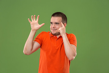 Image showing Young serious thoughtful businessman. Doubt concept.