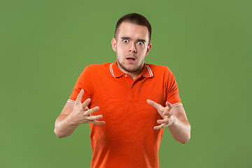 Image showing The young emotional angry and scared man standing and looking at camera