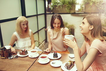 Image showing Two girl friends spend time together drinking coffee in the cafe, having breakfast and dessert.