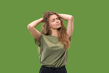 Image showing Woman having headache. Isolated over green background.