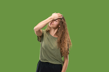 Image showing Woman having headache. Isolated over green background.