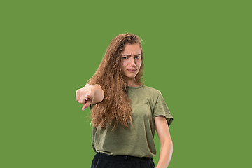 Image showing The overbearing business woman point you and want you, half length closeup portrait on green background.