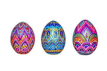 Image showing Wooden Easter eggs, painted in patterns by hand with acrylic paints, isolated on a white background.