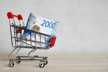 Image showing Russian money banknotes in a shopping trolley, online shopping concept.