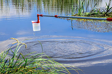 Image showing Take samples of water for laboratory testing. The concept - analysis of water purity, environment, ecology.