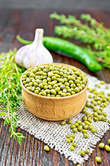 Image showing Mung beans in wooden bowl with thyme on burlap