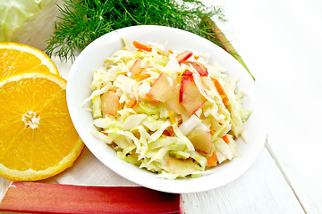 Image showing Salad of cabbage and rhubarb in plate on light board