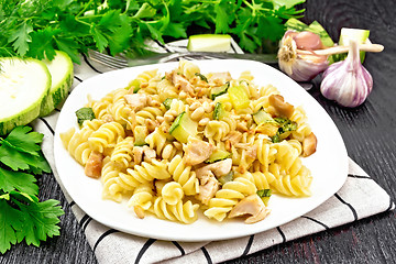 Image showing Fusilli with chicken and zucchini in plate on napkin