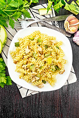 Image showing Fusilli with chicken and zucchini in plate on dark board top