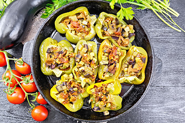 Image showing Pepper stuffed with vegetables in pan on board top