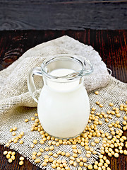 Image showing Milk soy in jug with soybeans and leaf on sacking