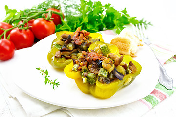 Image showing Pepper stuffed with vegetables in plate on light board