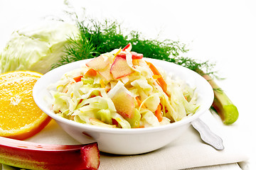 Image showing Salad of cabbage and rhubarb in plate on light wooden board