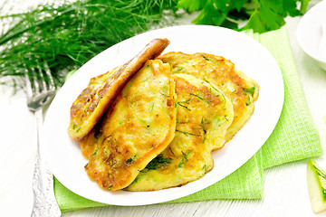 Image showing Pancakes of zucchini on board