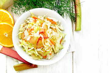 Image showing Salad of cabbage and rhubarb in plate on board top