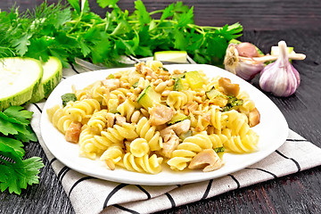 Image showing Fusilli with chicken and zucchini in plate on towel