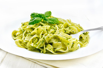 Image showing Pasta with pesto sauce in plate on white board