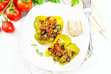 Image showing Pepper stuffed with vegetables in plate on light board top