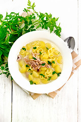 Image showing Soup creamy of chicken and pasta in plate on light board top