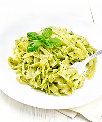 Image showing Pasta with pesto sauce in plate on napkin