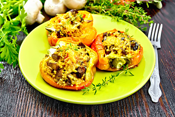 Image showing Pepper stuffed with mushrooms and couscous in green plate on tab