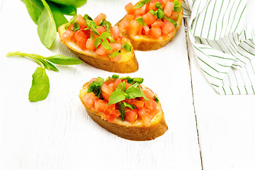 Image showing Bruschetta with tomato and spinach on table