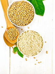 Image showing Flour soy with soybeans and leaf on wooden board top