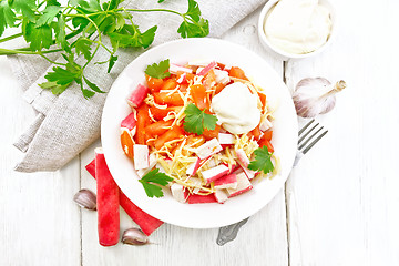 Image showing Salad of surimi and tomatoes on board top