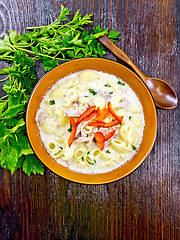 Image showing Soup creamy of chicken and pasta with pepper in plate on board t