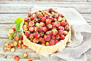 Image showing Strawberries in box on old board