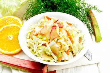 Image showing Salad of cabbage and rhubarb in plate on white wooden board