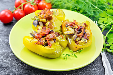 Image showing Pepper stuffed with vegetables in green plate on board