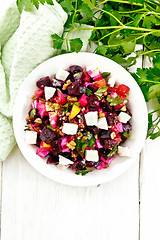 Image showing Salad with beetroot and feta in plate on light board top