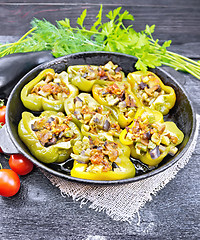Image showing Pepper stuffed with vegetables in pan on dark board