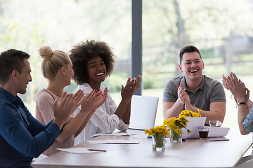 Image showing multiethnic startup Group of young business people celebrating s