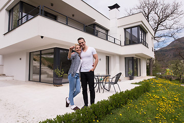 Image showing couple hugging in front of  new luxury home