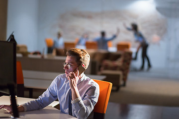 Image showing man using mobile phone in dark office