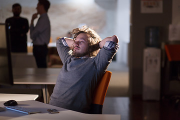 Image showing businessman relaxing at the desk