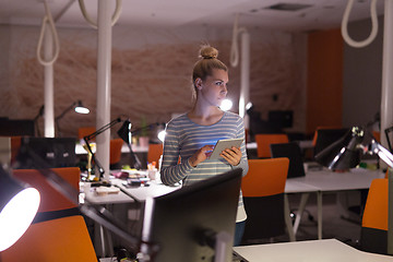 Image showing woman working on digital tablet in night office