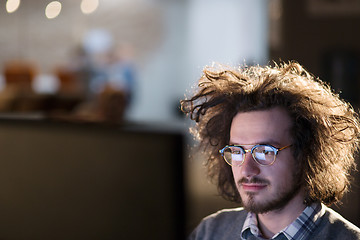 Image showing man working on computer in dark office