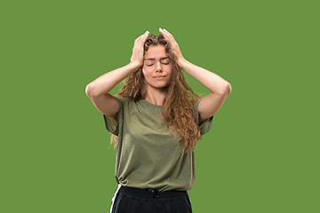 Image showing Woman having headache. Isolated over green background.