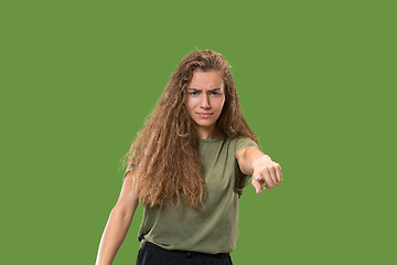 Image showing The overbearing business woman point you and want you, half length closeup portrait on green background.