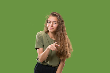 Image showing The overbearing business woman point you and want you, half length closeup portrait on green background.