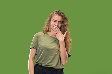 Image showing Let me think. Doubtful pensive woman with thoughtful expression making choice against green background